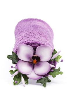 Purple towel and flower as a spa decoration isolated on white background