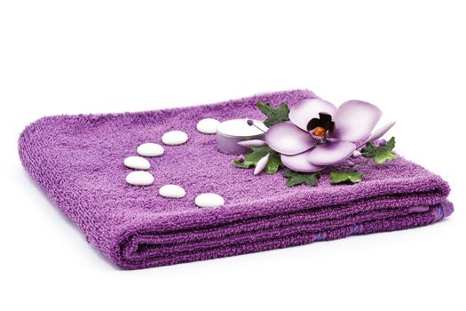 Purple towel and flower as a spa decoration isolated on white background