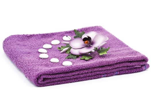 Purple towel and flower as a spa decoration isolated on white background
