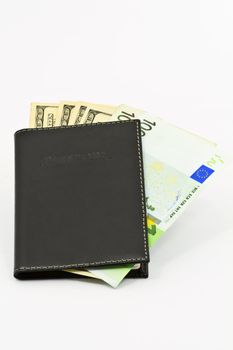 Passport and money, a travelers essential kit, isolated on white background