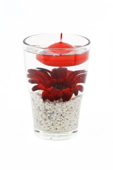 Flower and candle in glass as a decoration isolated on white