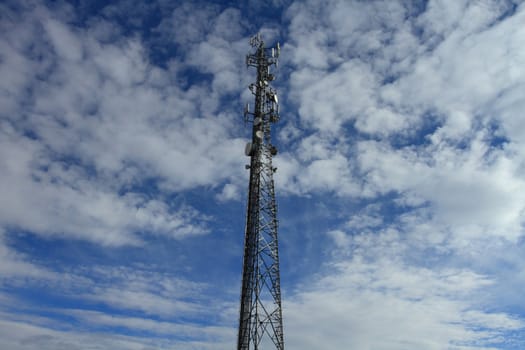 Large telecommunication tower with dramatic clouds in the sky