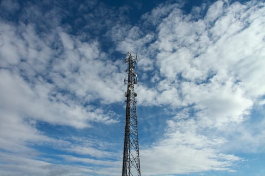 Large telecommunication tower with dramatic clouds in the sky