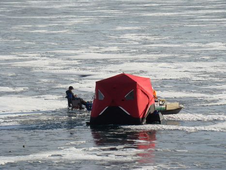 teen ice fishing on a sunny day