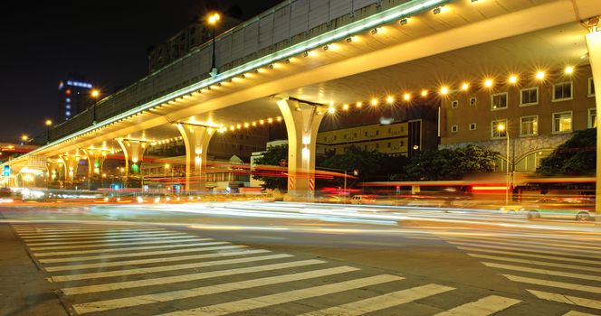 High speed traffic and blurred light trails under the overpass