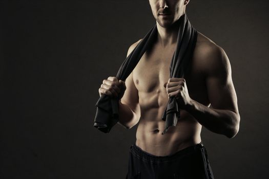 Muscular, shirtless man with towel around neck