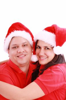 Young happy couple near with Santa hats. Isolated over white background