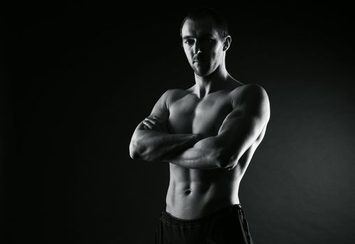 Fitness, young man crossed arms