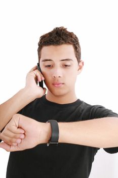 Portrait of a busy young male using mobile phone and looking at watch