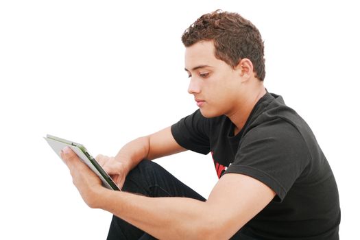 School boy with electronic tablet sitting in the floor