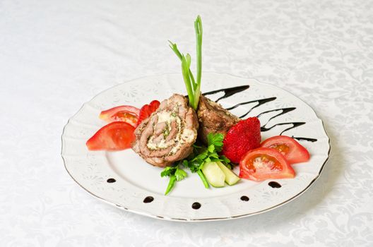 Pork rolls with cheese and vegetables: onion, cucumbers, tomatoes