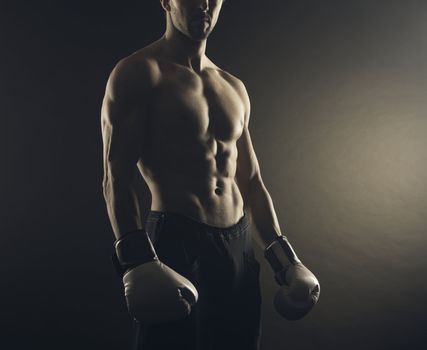 Male fighter posing in front of a dark background
