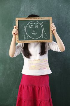 girl holding black board with drawing