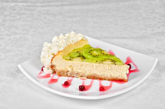 tasty kiwi fresh cake closeup at plate