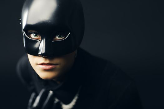 Portrait of female thief in black mask