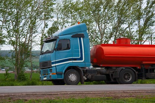 Truck is on  side of  road. This tank truck.