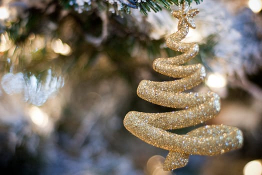 sparkling gold christmas tree ornament hanging on christmas tree