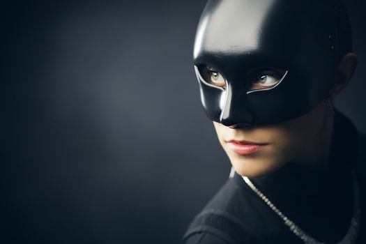 Portrait of female thief in black mask