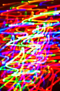 abstract glowing background resembling motion blurred neon light curves