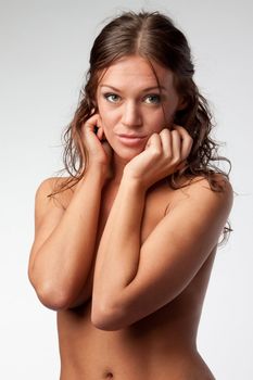 Portrait of the young and beautiful girl with naked shoulders