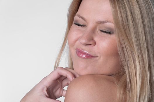 Portrait of the young and beautiful girl with naked shoulders