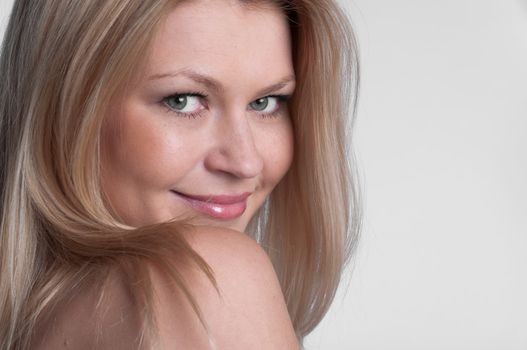 Portrait of the young and beautiful girl with naked shoulders