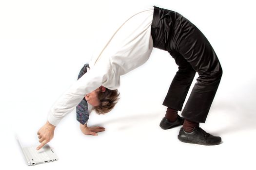 Young businessman yoga before an open notebook
