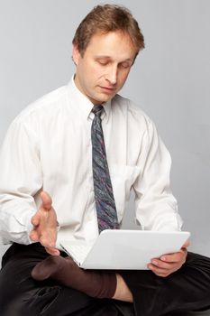Young businessman yoga before an open notebook