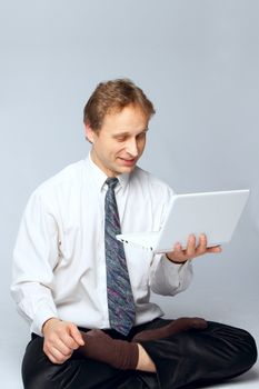 Young businessman yoga before an open notebook