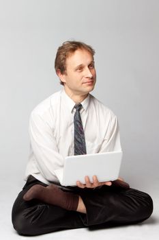 Young businessman yoga before an open notebook