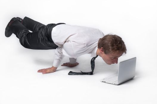 Young businessman yoga before an open notebook