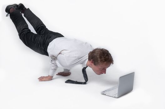 Young businessman yoga before an open notebook