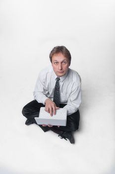 Young businessman yoga before an open notebook