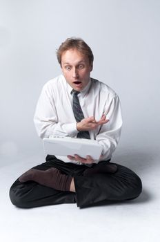 Young businessman yoga before an open notebook
