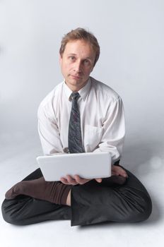 Young businessman yoga before an open notebook
