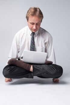 Young businessman yoga before an open notebook