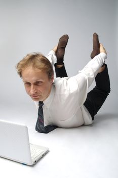 Young businessman yoga before an open notebook