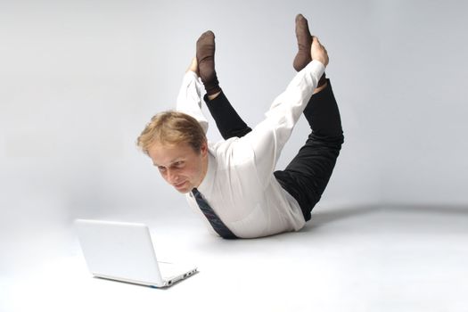 Young businessman yoga before an open notebook