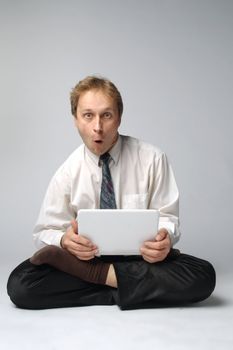 Young businessman yoga before an open notebook