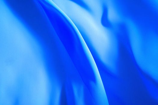blue fabric winds waves, creating a beautiful background of the folds