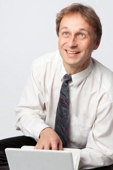 Portrait of middle-aged man with a white laptop computer