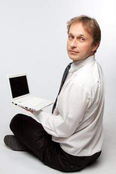 Portrait of middle-aged man with a white laptop computer