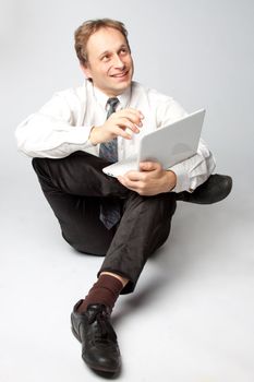Portrait of middle-aged man with a white laptop computer