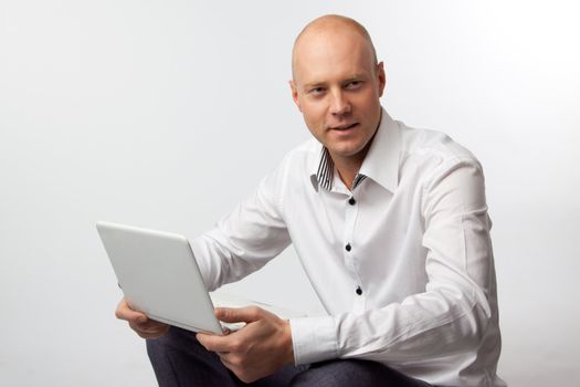 Portrait of middle-aged man with a white laptop computer