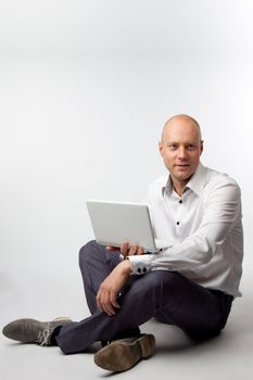 Portrait of middle-aged man with a white laptop computer