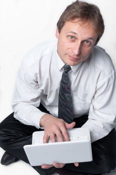 Portrait of middle-aged man with a white laptop computer