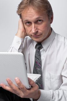 Portrait of middle-aged man with a white laptop computer