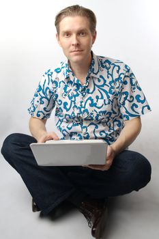 Portrait of middle-aged man with a white laptop computer