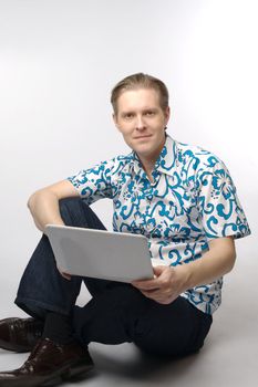 Portrait of middle-aged man with a white laptop computer