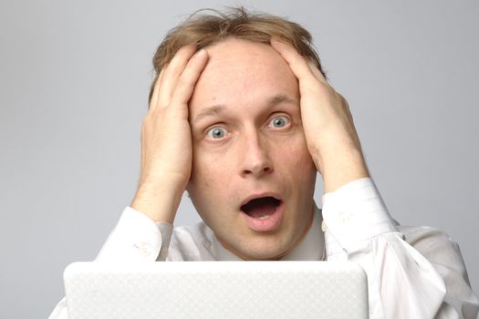 Portrait of middle-aged man with a white laptop computer